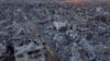 An aerial photograph taken by a drone shows Palestinians walking through the destruction caused by the Israeli air and ground offensive, in Rafah, Gaza Strip, Jan. 24, 2025. 