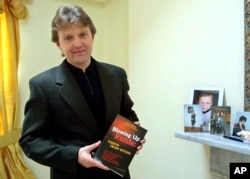 FILE - Former KGB spy Alexander Litvinenko, author of 'Blowing Up Russia,' is shown at home in 2002.