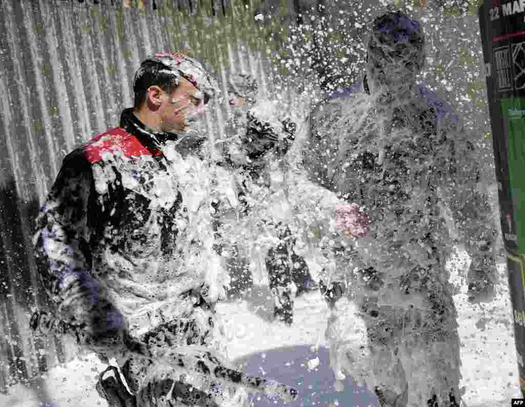 Members of the Catalan Regional Police (Mossos d&#39;Esquadra) are sprayed with foam during a firefighters&#39; demonstration against the government&#39;s spending cuts in social services, Barcelona. Spain.