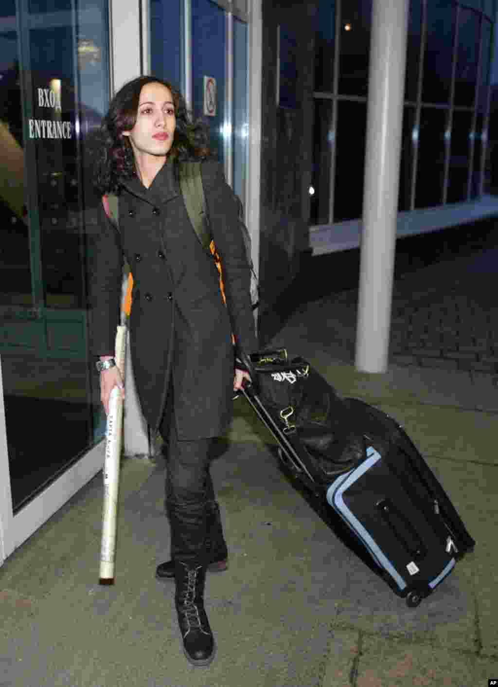 Greenpeace International activist Faiza Oulahsen of the Netherlands arrives at St. Petersburg airport to catch a flight after receiving her exit visa from the Federal Migration Service, St. Petersburg, Russia, Dec. 27, 2013.