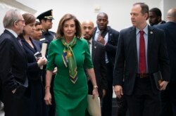 Speaker of the House Nancy Pelosi, D-Calif., joined by House Intelligence Committee Chairman Adam Schiff, D-Calif., right, leaves a lengthy closed-door meeting with the Democratic Caucus at the Capitol in Washington, Jan. 14, 2020.
