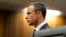 Olympic and Paralympic track star Oscar Pistorius stands in the dock during his trial at the North Gauteng High Court in Pretoria, South Africa, March 3, 2014.