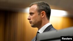 Olympic and Paralympic track star Oscar Pistorius stands in the dock during his trial at the North Gauteng High Court in Pretoria, South Africa, March 3, 2014.