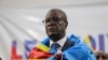 FILE - Democratic Republic of Congo doctor and activist Denis Mukwege, who won the Nobel Peace Prize in 2018, stands wrapped in the national flag after he announced his candidacy for president in Kinshasa on Oct. 2, 2023.