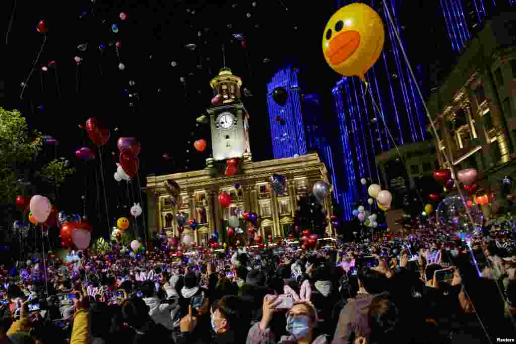 People gather to celebrate the arrival of the new year during the coronavirus disease (COVID-19) outbreak in Wuhan, China.