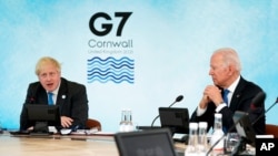 FILE - British Prime Minister Boris Johnson speaks as President Joe Biden listens during the G-7 summit at the Carbis Bay Hotel in Carbis Bay, St. Ives, Cornwall, England, June 11, 2021. 