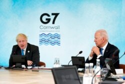 British Prime Minister Boris Johnson speaks as President Joe Biden listens during the G-7 summit at the Carbis Bay Hotel in Carbis Bay, St. Ives, Cornwall, England, June 11, 2021.