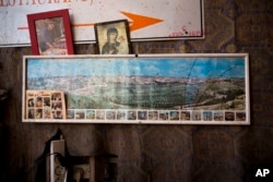 A framed photo of Jerusalem's Old City hangs in a juice stand, in Jerusalem's Old City, Dec. 5, 2017. The U.S. Consulate General in Jerusalem on Dec. 5 barred personal travel by American government workers and their families in Jerusalem's Old City and West Bank, including Bethlehem and Jericho, until further notice.