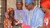 Nigerian President Muhammadu Buhari, second from right, receives Amina Ali, the rescued Chibok schoolgirl, at the presidential palace in Abuja, May 19, 2016. 