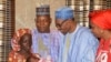 Nigeria President Muhammadu Buhari, second right, receives Amina Ali, the rescued Chibok school girl, at the Presidential palace in Abuja, Nigeria, May. 19, 2016. 