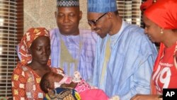 Nigerian President Muhammadu Buhari, second from right, receives Amina Ali, the rescued Chibok schoolgirl, at the presidential palace in Abuja, May 19, 2016. 