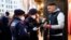 Police officers check the vaccination status of visitors during a patrol on a Christmas market in Vienna, Austria, Nov. 19, 2021. 