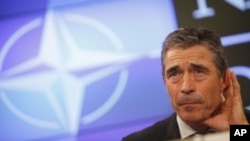 NATO Secretary-General Anders Fogh Rasmussen listens to a question during a media conference at the Residence Palace in Brussels, July 6, 2011