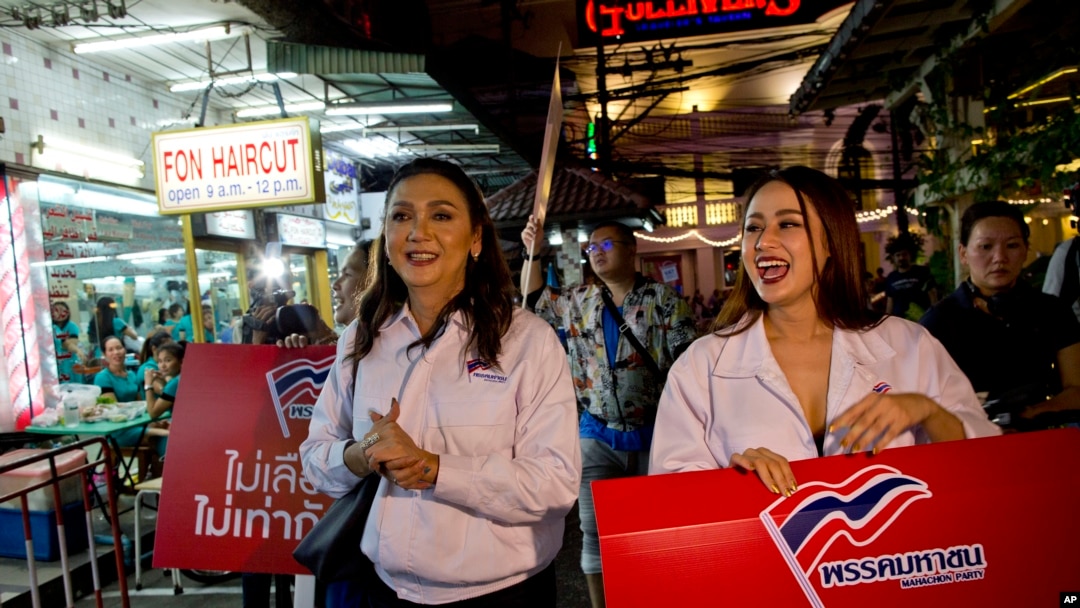 Pauline Ngarmpring, left, a transgender person and a prime minister candidate, and Namklenginarin, right, also a candidate, both representing Mahachon Party for upcoming Thai general election, campaign in Bangkok, Feb. 13, 2019.