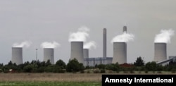 FILE - The cooling towers at Eskom's coal-powered Lethabo power station are seen near Sasolburg, South Africa.