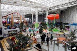 Visitors to the American Dream mega entertainment and shopping complex in East Rutherford, N.J., use the Nickelodeon Universe theme park, Friday, Oct. 25, 2019. (AP Photo/Richard Drew)