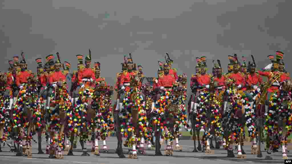 A Pakistani camel-mounted military band performs during a Pakistan Day military parade in Islamabad.