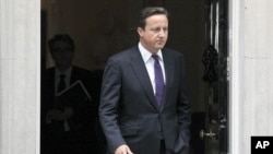 Britain's Prime Minister David Cameron leaves Downing Street in London, to attend Parliament, August 11, 2011