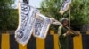 An Afghan man sells Taliban flags along a street on the eve of the third anniversary of Taliban takeover of Afghanistan, in Kabul on Aug. 13, 2024. 