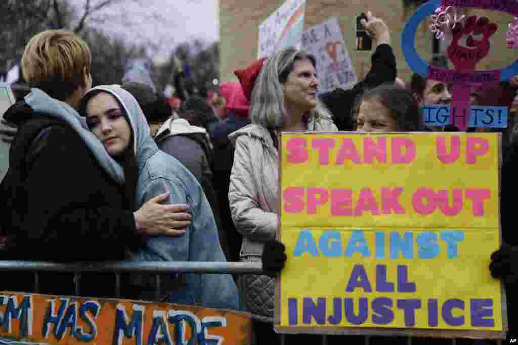 Protestors wait for speakers to begin their speeches in the cold along the barricades at the Women's March on Washington during the first full day of Donald Trump's presidency, Jan. 21, 2017 in Washington. 