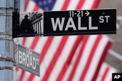 A sign outside the New York Stock Exchange marks the intersection of Wall and Broad Streets, Jan. 28, 2025, in New York.