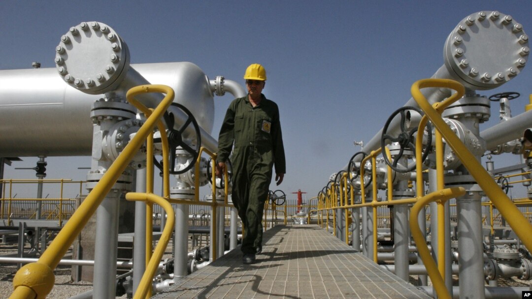 FILE - Iranian oil technician Majid Afshari makes his way to the oil separator facilities in Iran's Azadegan oil field southwest of Tehran, Iran, April 15, 2008.