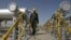 Iranian oil technician Majid Afshari makes his way to the oil separator facilities in Iran's Azadegan oil field southwest of Tehran, Iran, April 15, 2008 (file photo).