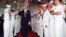 FILE - In this Oct. 6, 1994 file photo, President Bill Clinton salutes sailors aboard the USS Eisenhower in Norfolk, Va. Clinton's "don't ask, don't tell" policy prohibited gay men and women from serving openly in the armed forces. Congress eventually repealed the policy.