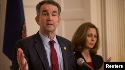 FILE - Virginia Governor Ralph Northam, accompanied by his wife Pamela Northam, announces he will not resign during a news conference Richmond, Virginia, Feb. 2, 2019.