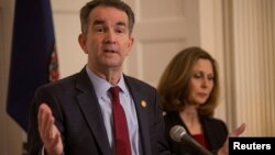 FILE - Virginia Governor Ralph Northam, accompanied by his wife Pamela Northam, announces he will not resign during a news conference Richmond, Virginia, Feb. 2, 2019.