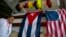 A man walks past Cuban and U.S. flags at the 33rd Havana International Fair (FIHAV) in Havana, Cuba, Nov. 2, 2015. 