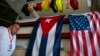 FILE - A man walks past Cuban and U.S. flags at the 33rd Havana International Fair (FIHAV) in Havana, Cuba, Nov. 2, 2015. 