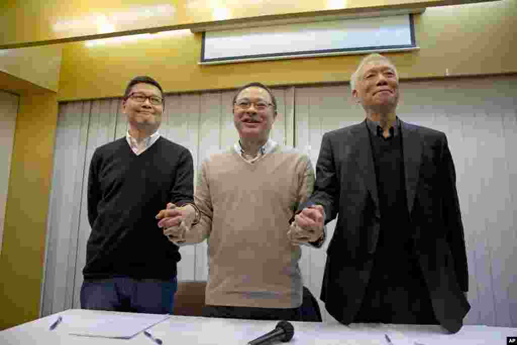 Three protest leaders, from left, Chan Kin-man, Benny Tai Yiu-ting and Reverend Chu Yiu-ming, announce that they will surrender to police, during a news conference in Hong Kong, Dec. 2, 2014.