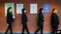 In this Monday, March 8, 2021 file photo, pupils queue for a socially distanced assembly at a school in in Manchester, England. 