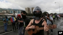 FILE - Anti-government demonstrators protest President Nicolas Maduro along a highway in Caracas, Venezuela, June 19, 2017.