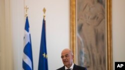 FILE - Greek Foreign Minister Nikos Dendias speaks during a news conference with his Spanish counterpart, Arancha Gonzalez Laya, after their meeting in Athens, July 28, 2020. 