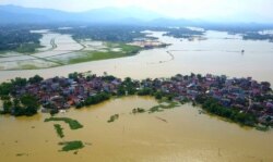 FILE - A village is submerged in flood water on the outskirts of Hanoi, Vietnam, July 22, 2018.