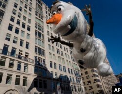 The Olaf balloon glides over Central Park West during the Macy's Thanksgiving Day Parade in New York, Thursday, Nov. 23, 2017.