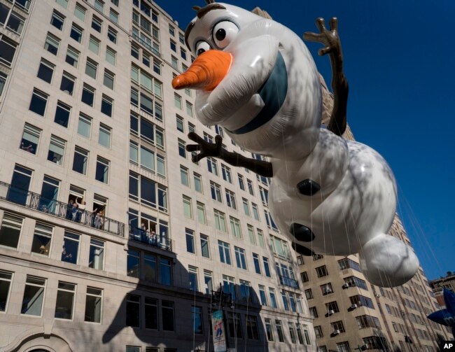 The Olaf balloon glides over Central Park West during the Macy's Thanksgiving Day Parade in New York, Thursday, Nov. 23, 2017.