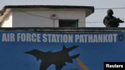 An Indian security personnel stands guard on a building at the Indian Air Force (IAF) base at Pathankot in Punjab, India, Jan. 5, 2016. 