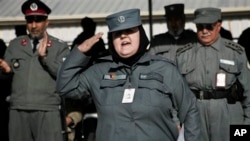 An Afghan policewoman salutes after receiving certification during a graduation ceremony, Herat, Jan. 10, 2013.