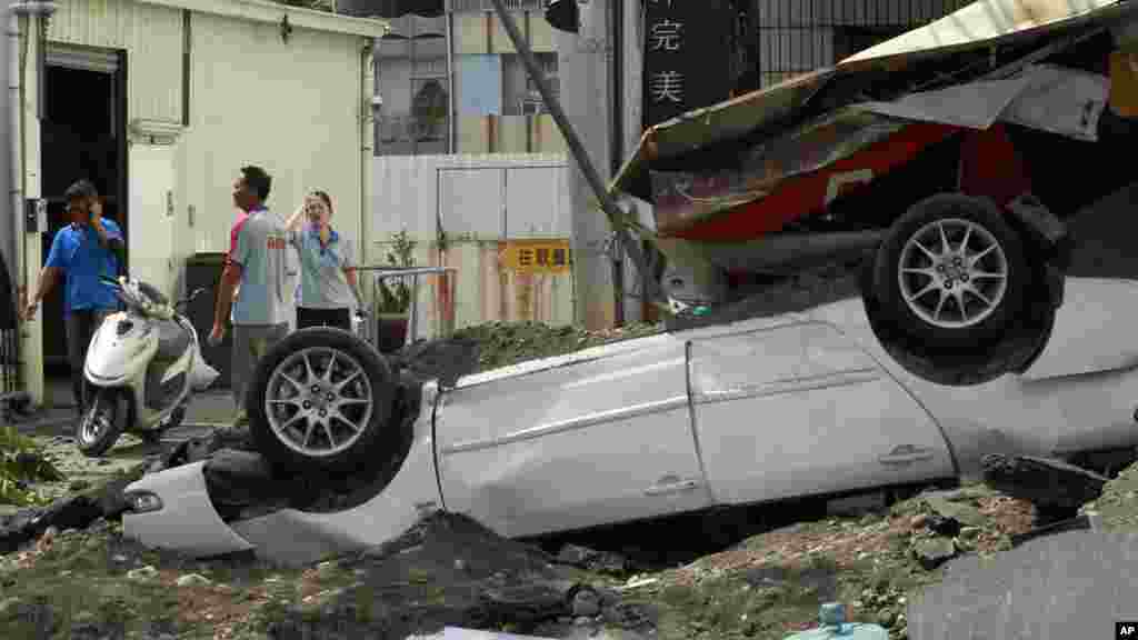 Locals survey the damage from a massive gas explosion in Kaohsiung, Taiwan, Aug. 1, 2014. 