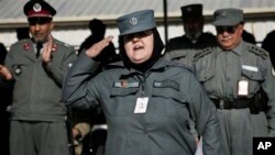 An Afghan policewoman salutes after receiving certification during a graduation ceremony, Herat, Jan. 10, 2013.