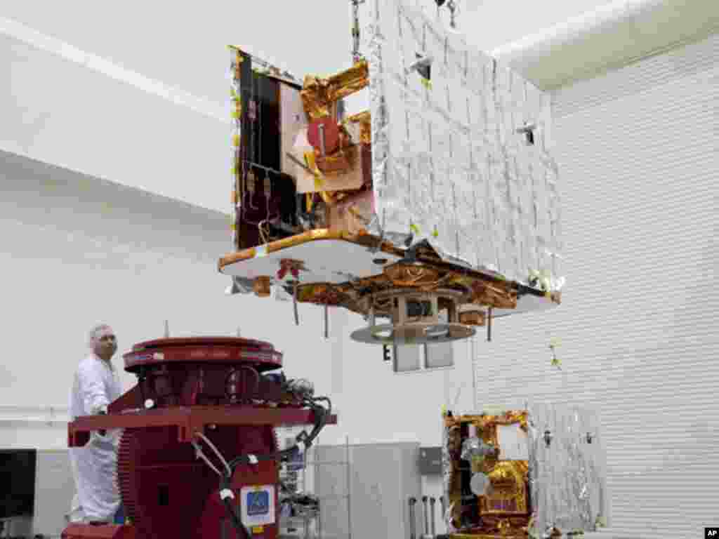 Technicians lift one of two spacecraft for NASA's GRAIL to a test stand in the Astrotech payload processing facility in Titusville, Florida. (NASA)