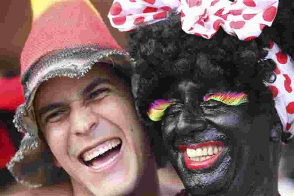 Revelers smile during the Banda de Ipanema carnival parade in Rio de Janeiro, Brazil, Saturday, Feb. 19, 2011. Hundreds of people gathered Saturday during one of the many parades which take place in the city before the famed 'Carnival' which this year run