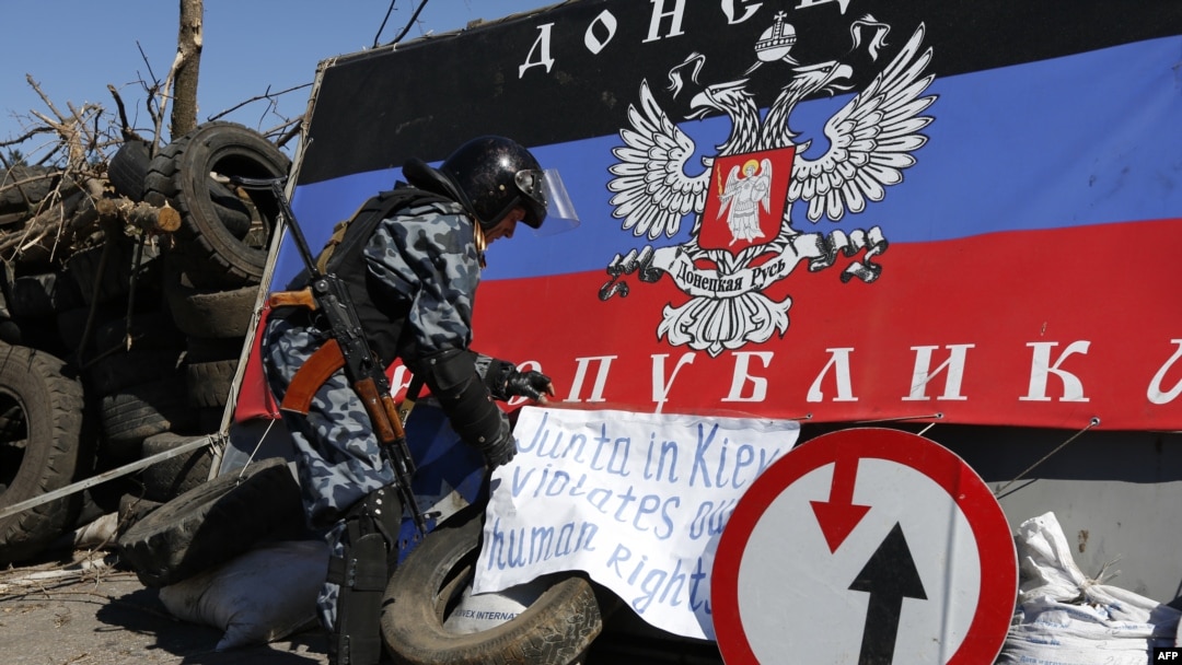 Pria bersenjata pro-Rusia di sebuah pos pemeriksaan di luar kota Slavyansk, Ukraina timur (26/4). (AFP/Max Vetrov)