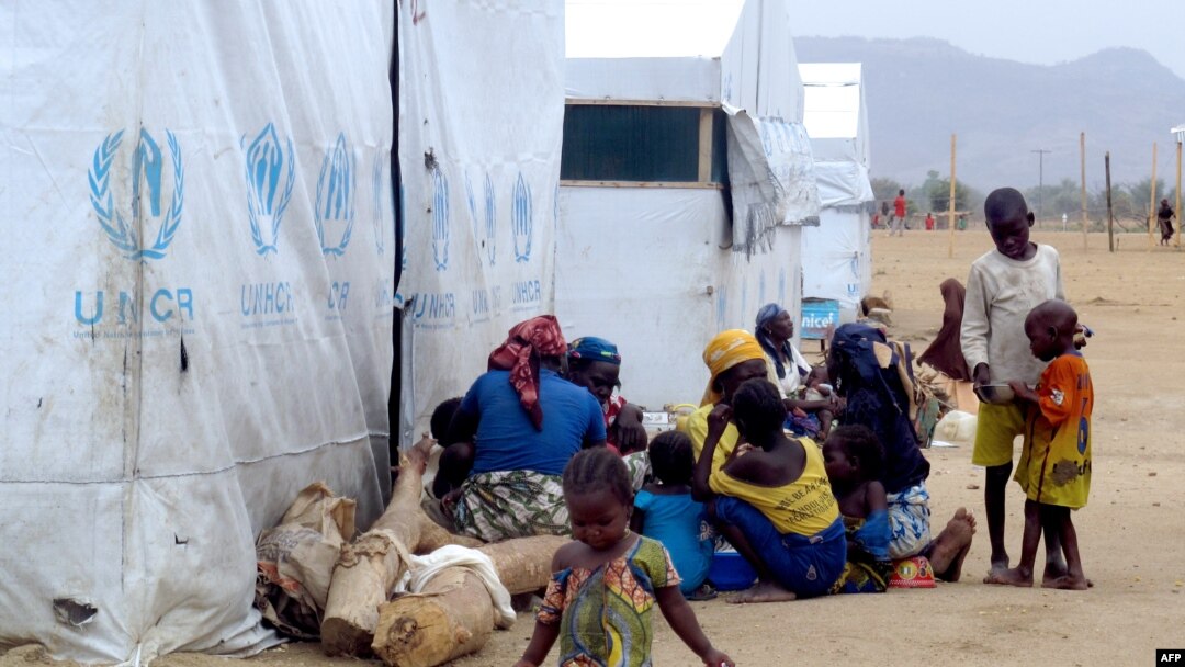 Para pengungsi Nigeria duduk di samping tenda UNHCR di kamp pengungsi di Minawao, di perbatasan Nigeria (29/3/2014). 