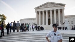 People line up at the Supreme Court on the first day of the new term, on Capitol Hill in Washington, Oct. 1, 2018. 