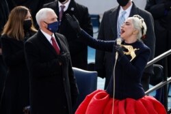 Lady Gaga sings the National Anthem as U.S. Vice President Mike Pence looks on during the National Anthem during the inauguration of Joe Biden as the 46th President of the United States on the West Front of the U.S. Capitol in Washington.