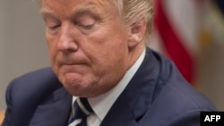 President Donald Trump pauses as he speaks during a meeting in the Roosevelt Room of the White House, Jan. 11, 2018.